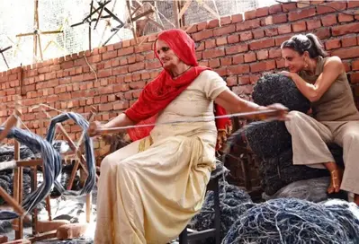 Woman hand spinning wool into yarn
