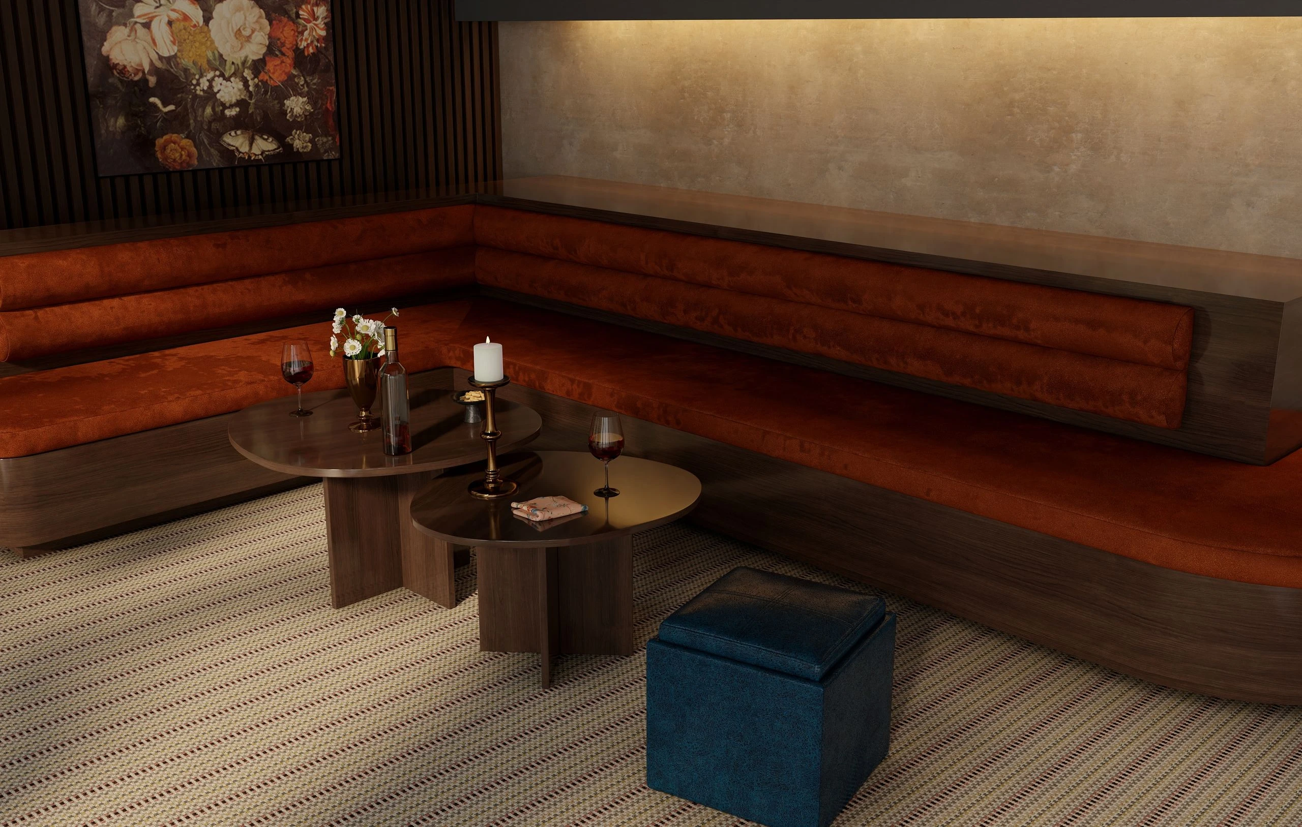 Lounge with a rust leather banquette and round tables over a One Love striped carpet