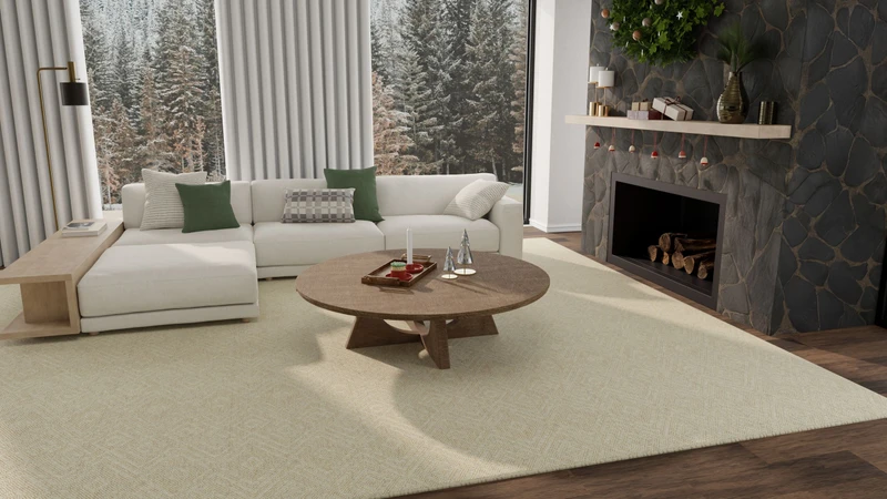 Living room with a cream sectional, round wooden coffee table, and holiday greenery on a cream Affirmed in Beige rug beside a stone fireplace