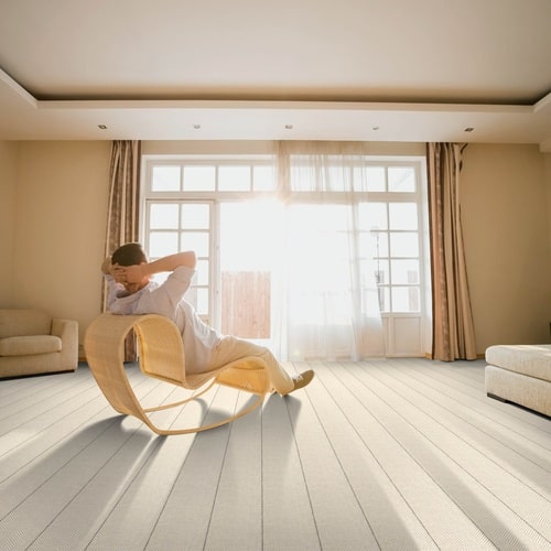 Grey wool carpet in a room with man rocking in a chair