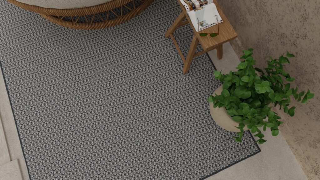 Multi-dimensional textured denim outdoor rug from Kaleen featured on an outdoor patio